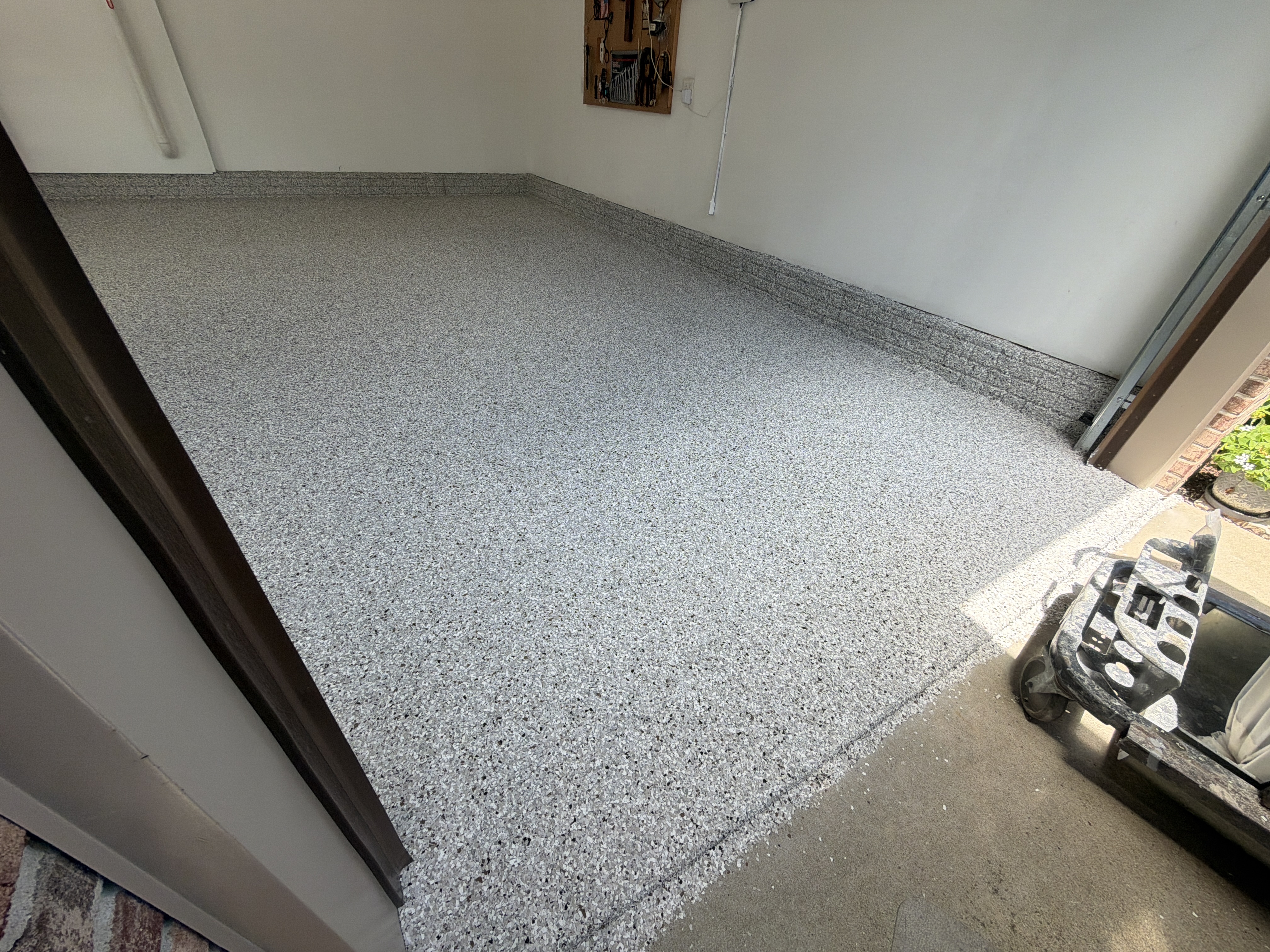 Spreading the base coat evenly across the garage floor