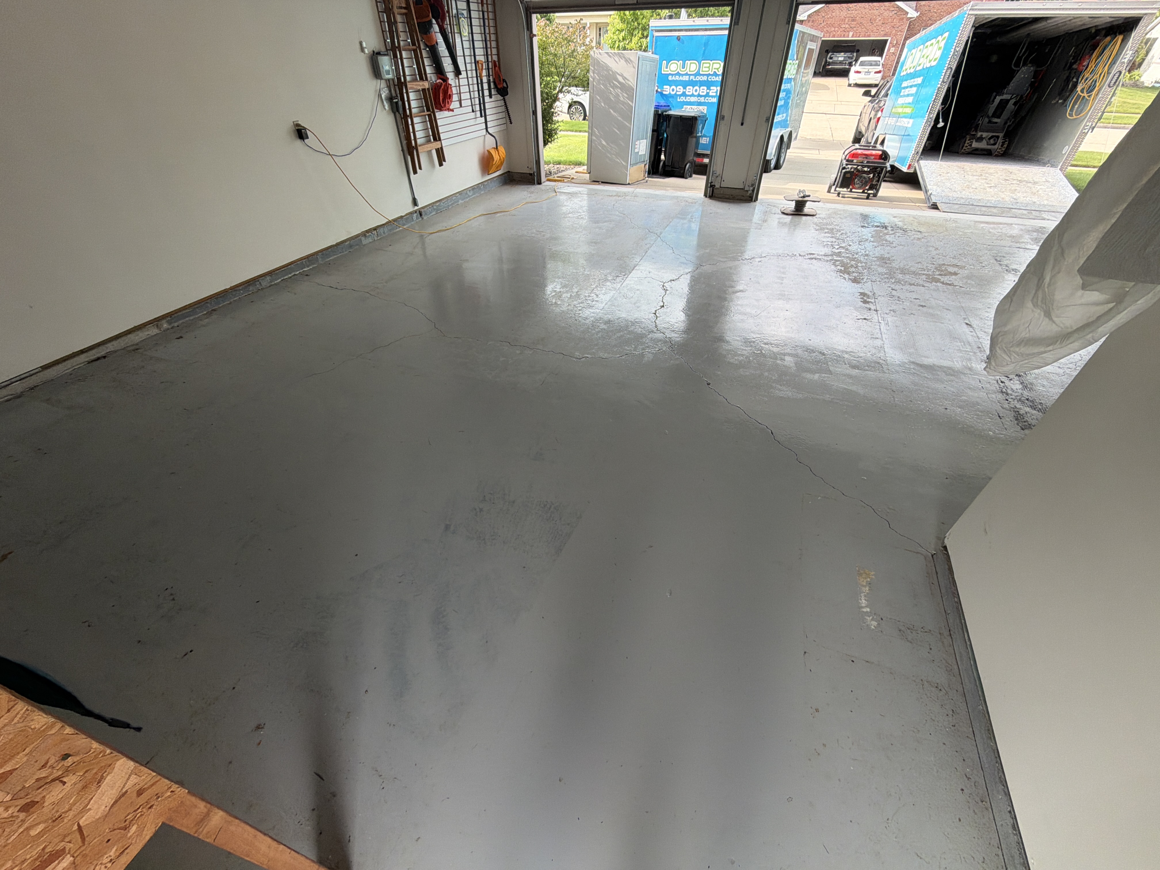 Pre-inspection photo showing the garage floor's existing damage