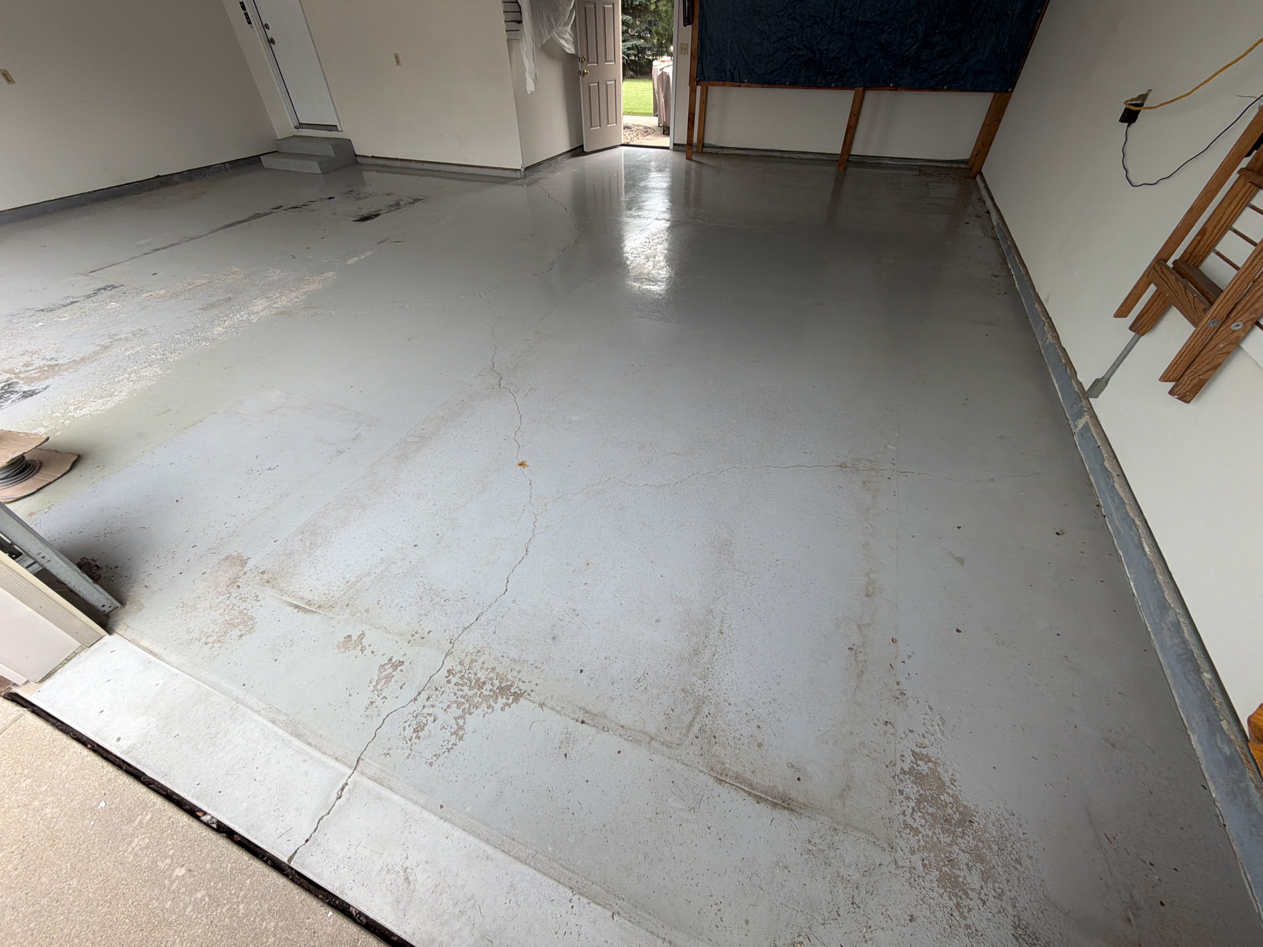 Close-up of dirty and worn concrete garage floor