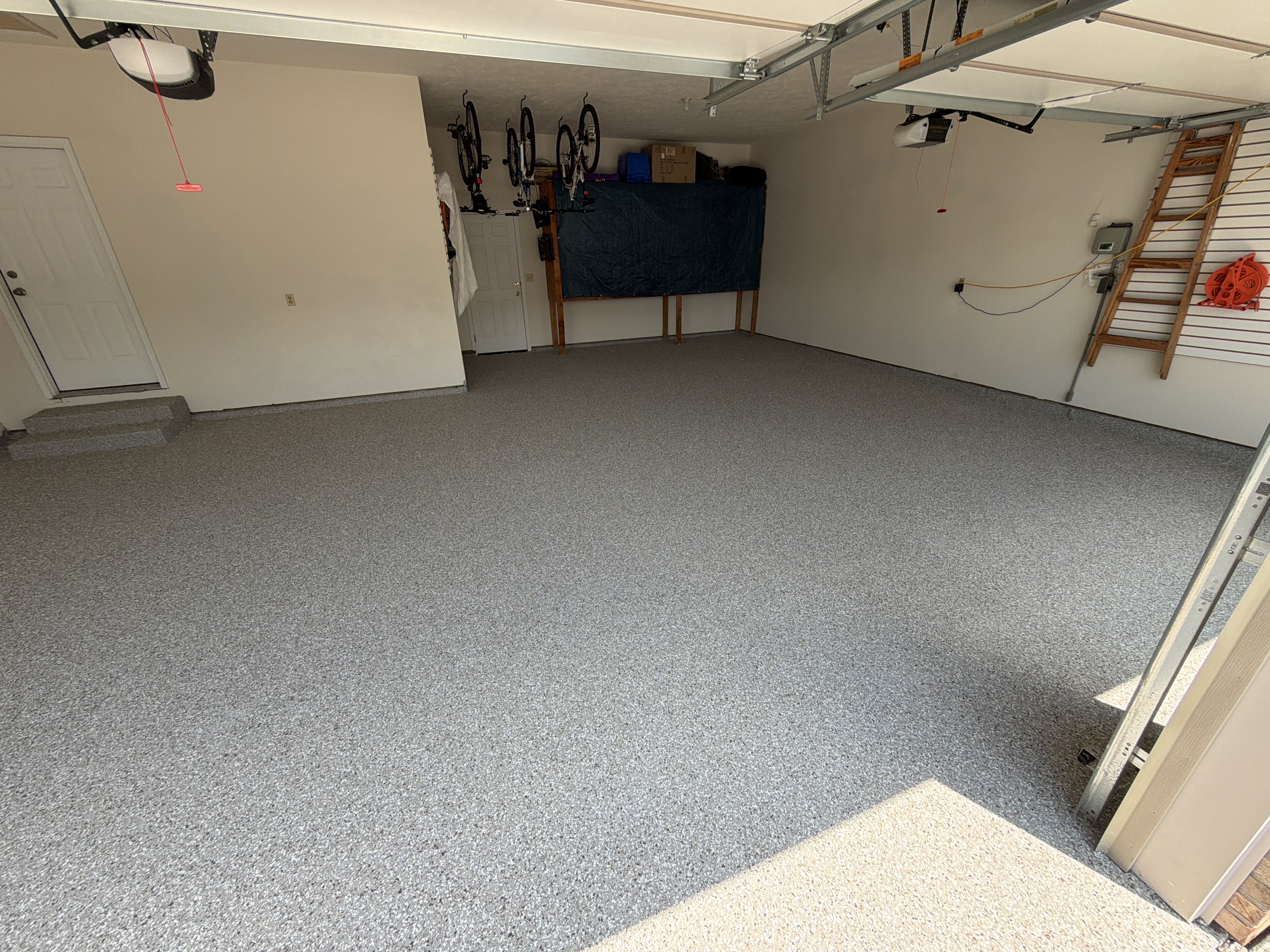 Applying the base coat to the garage floor