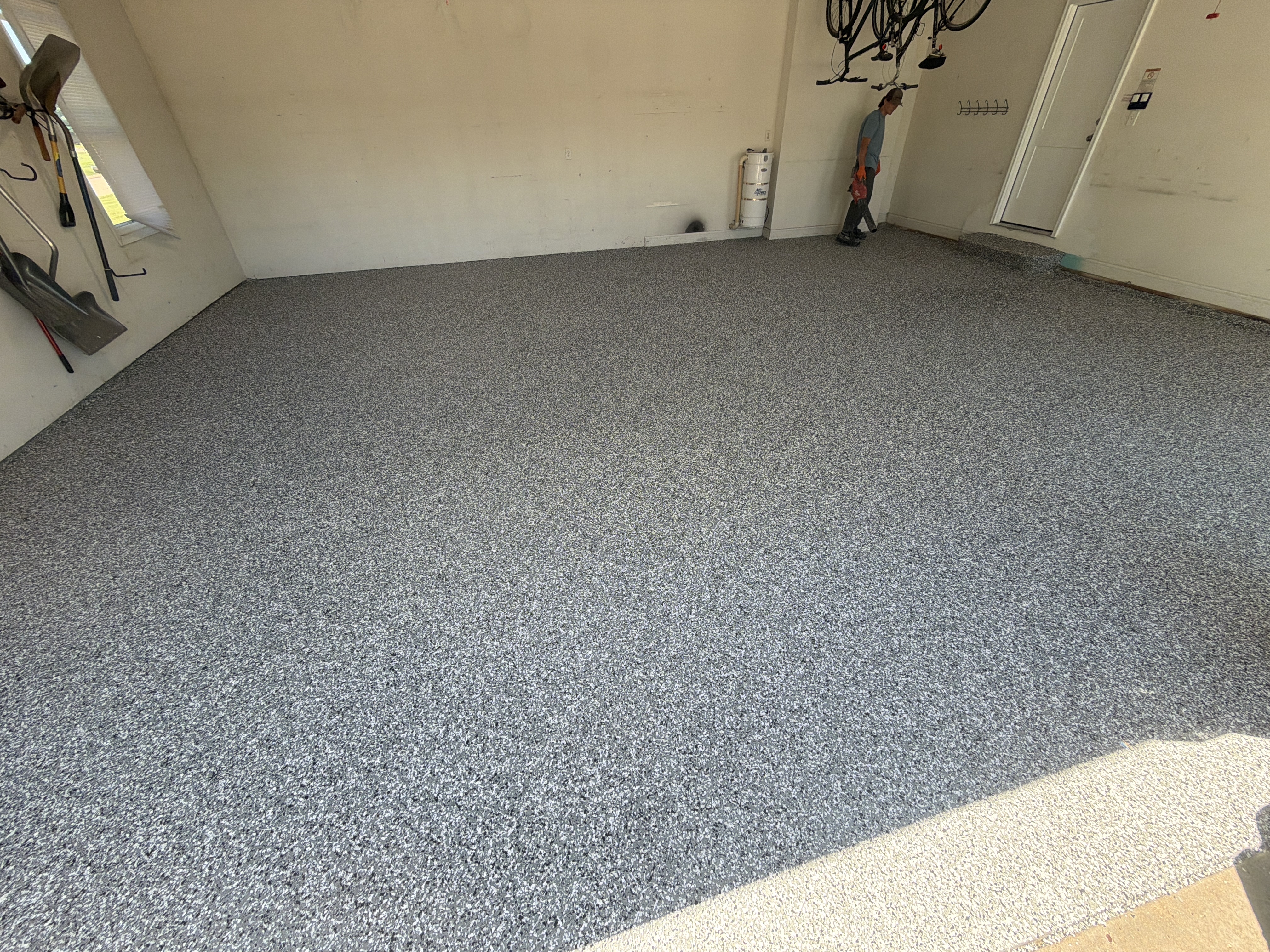 Applying the Wombat polyaspartic base coat to Jeremy's garage floor.