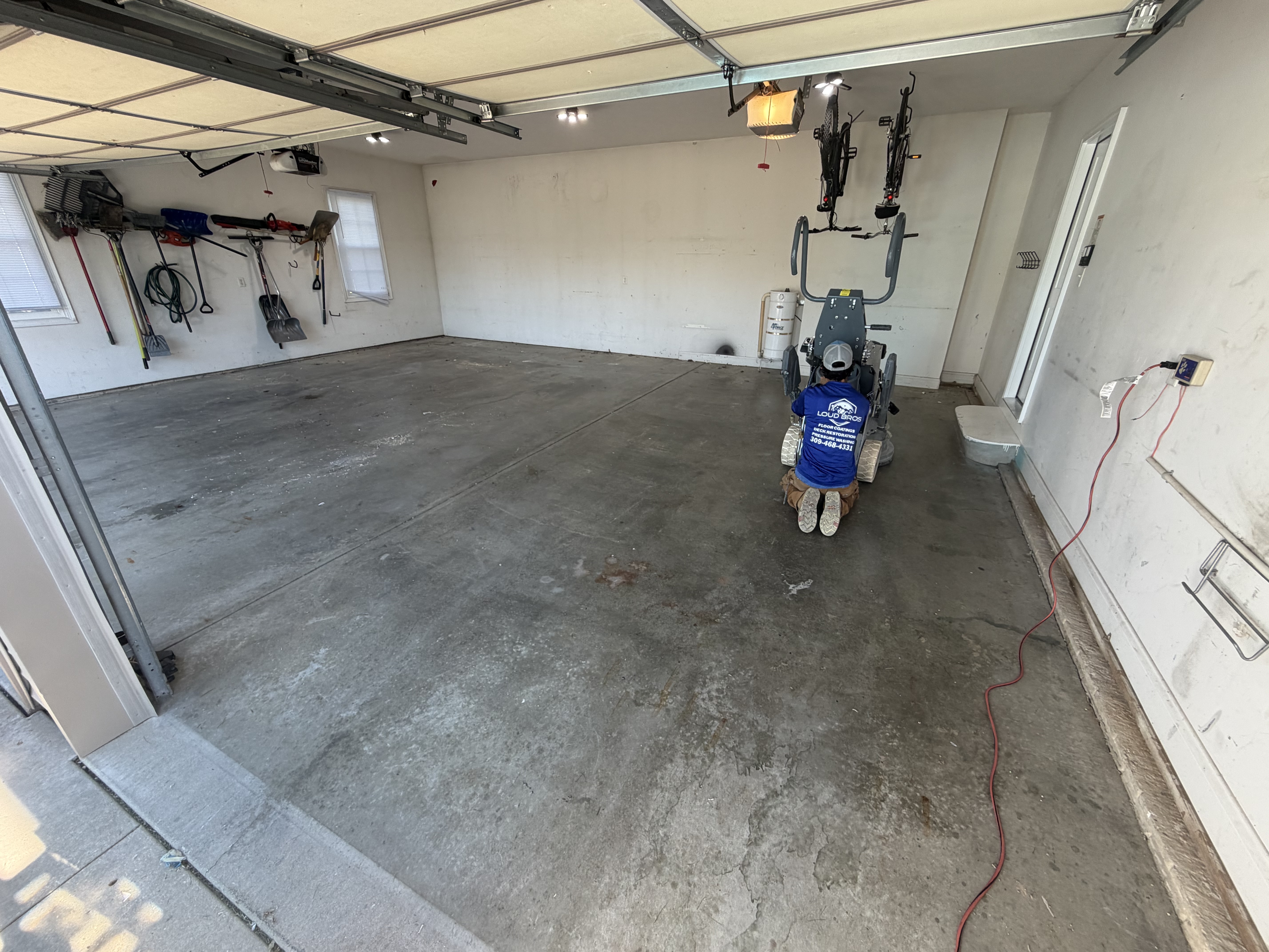 Jeremy's garage floor before the transformation, showing a dull, stained concrete surface.