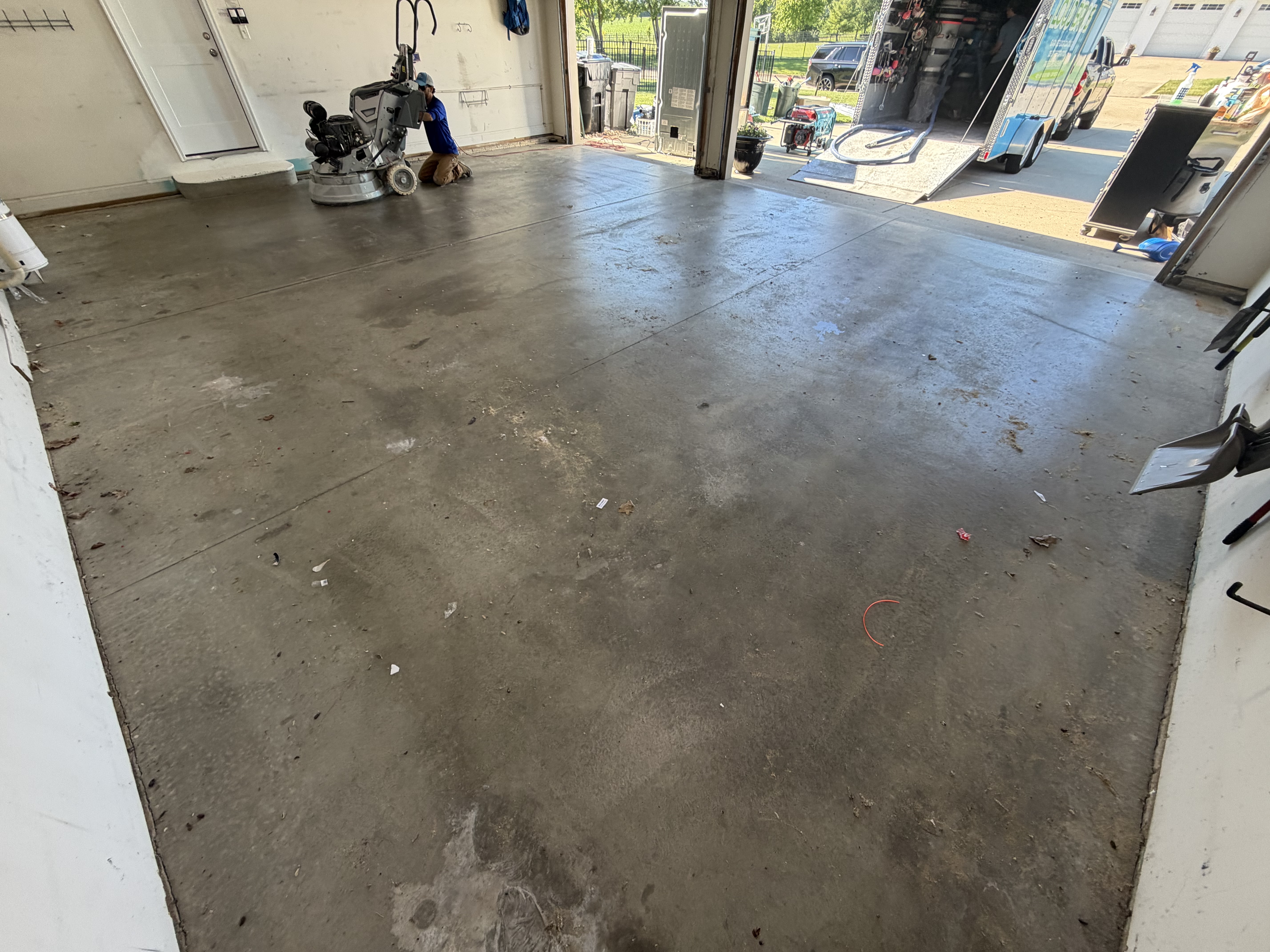 Another angle of the garage floor during pre-inspection, highlighting areas needing attention.
