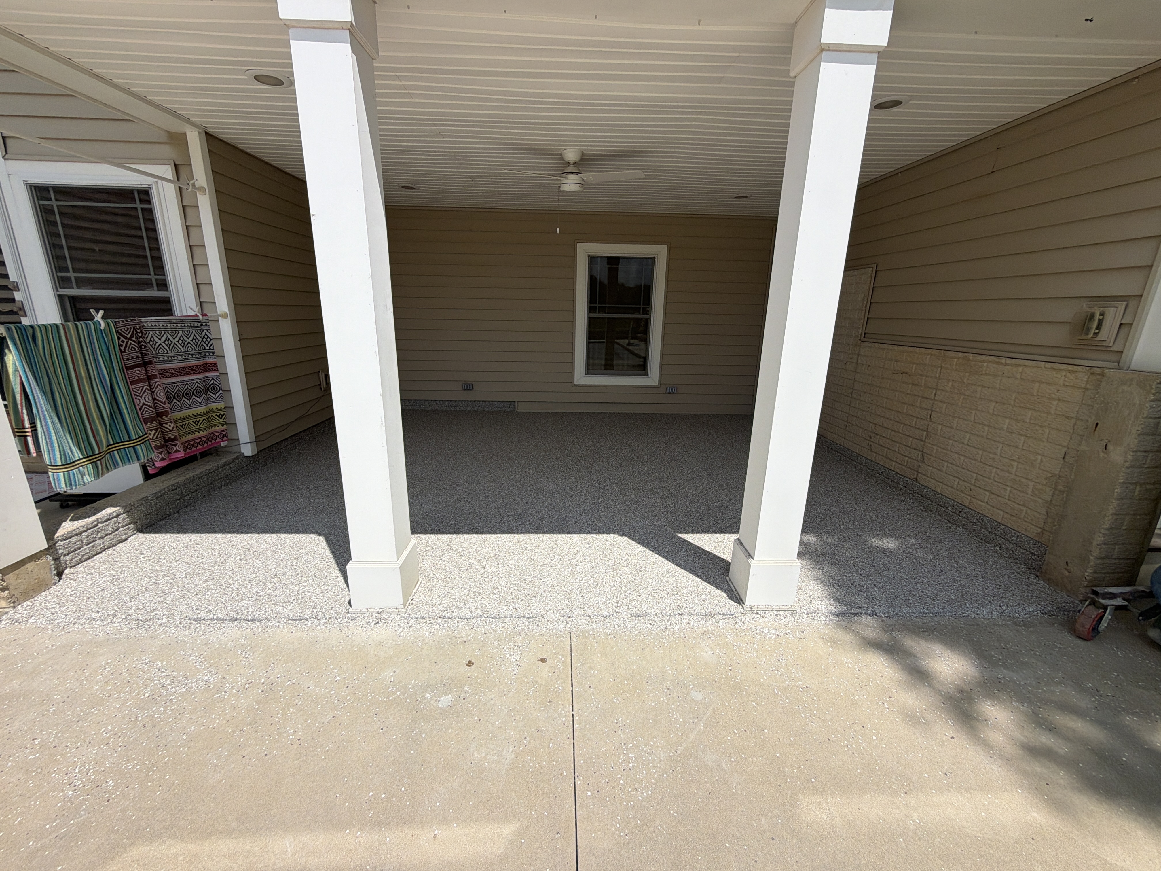 Applying the durable base coat to Lisa's patio in Armington