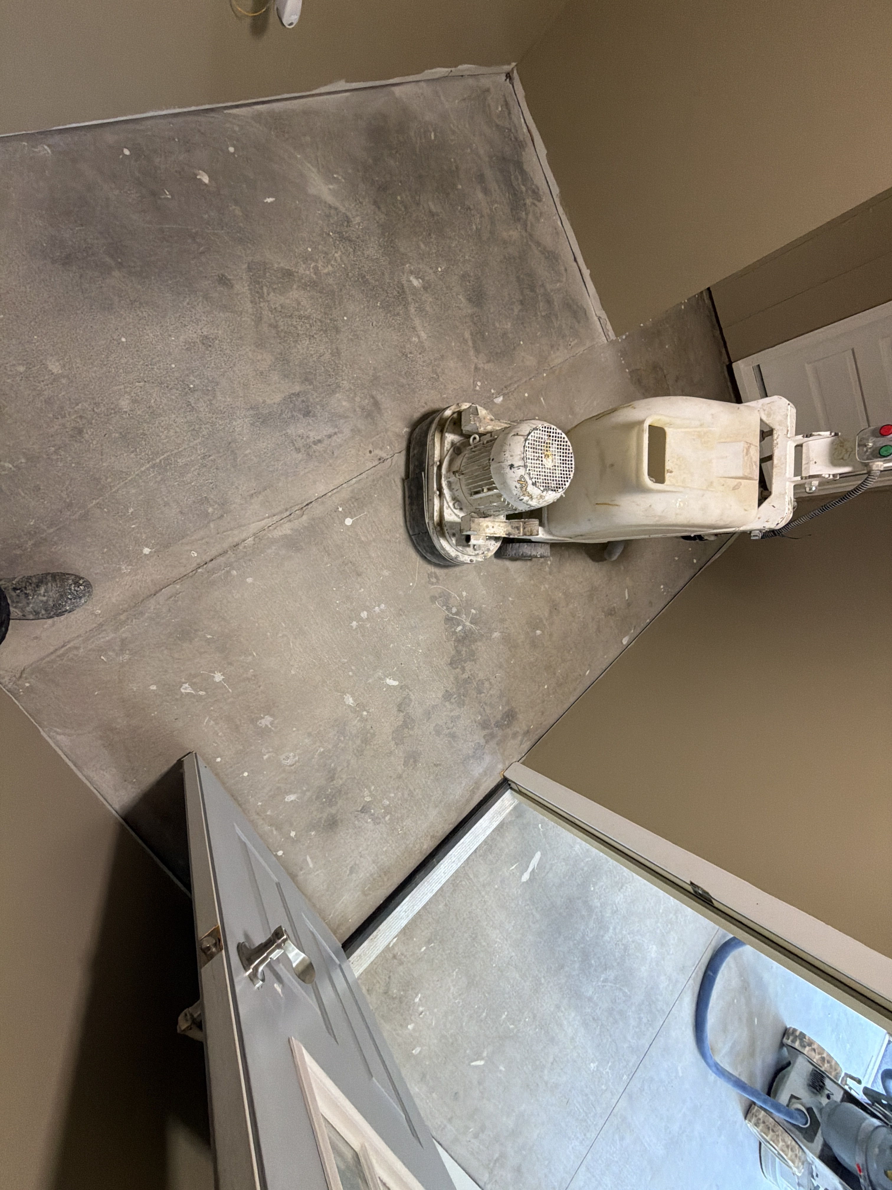 Another view of the original concrete floor, illustrating the uneven color and potential for further damage.