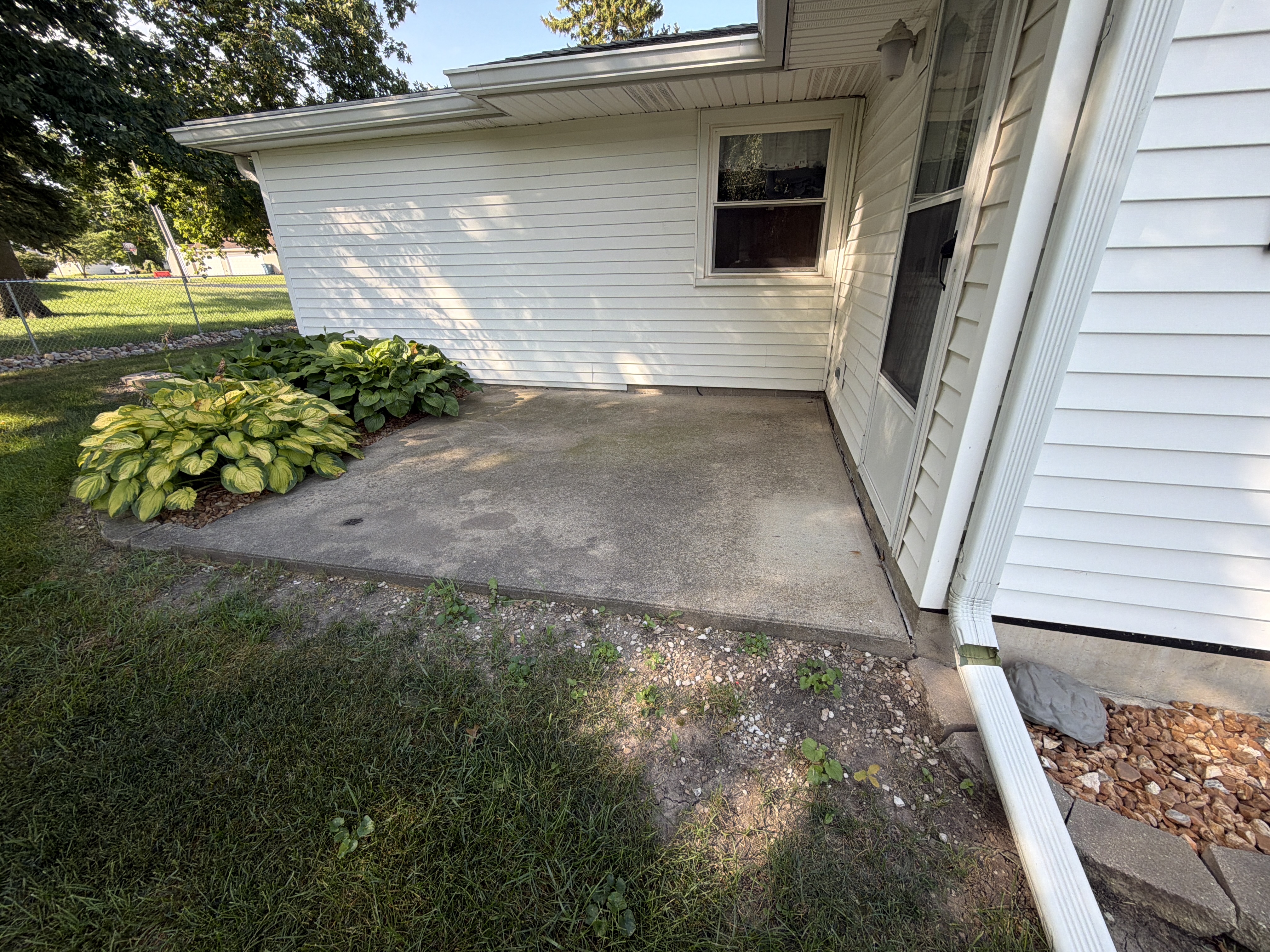 The bare concrete in Lonnie's garage before any work began, revealing a typical worn-out appearance.