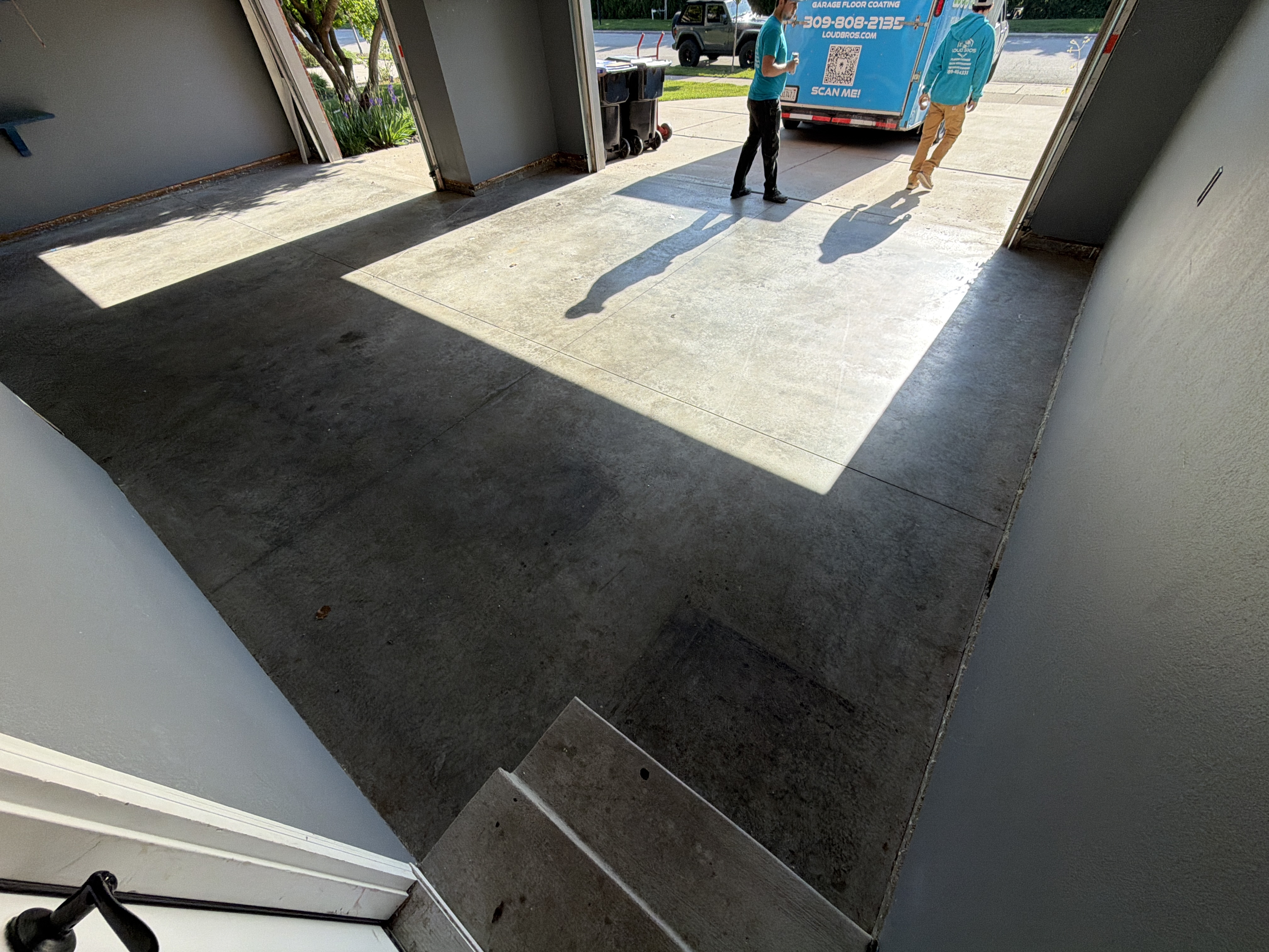 Initial state of the garage floor before Loud Bros' intervention