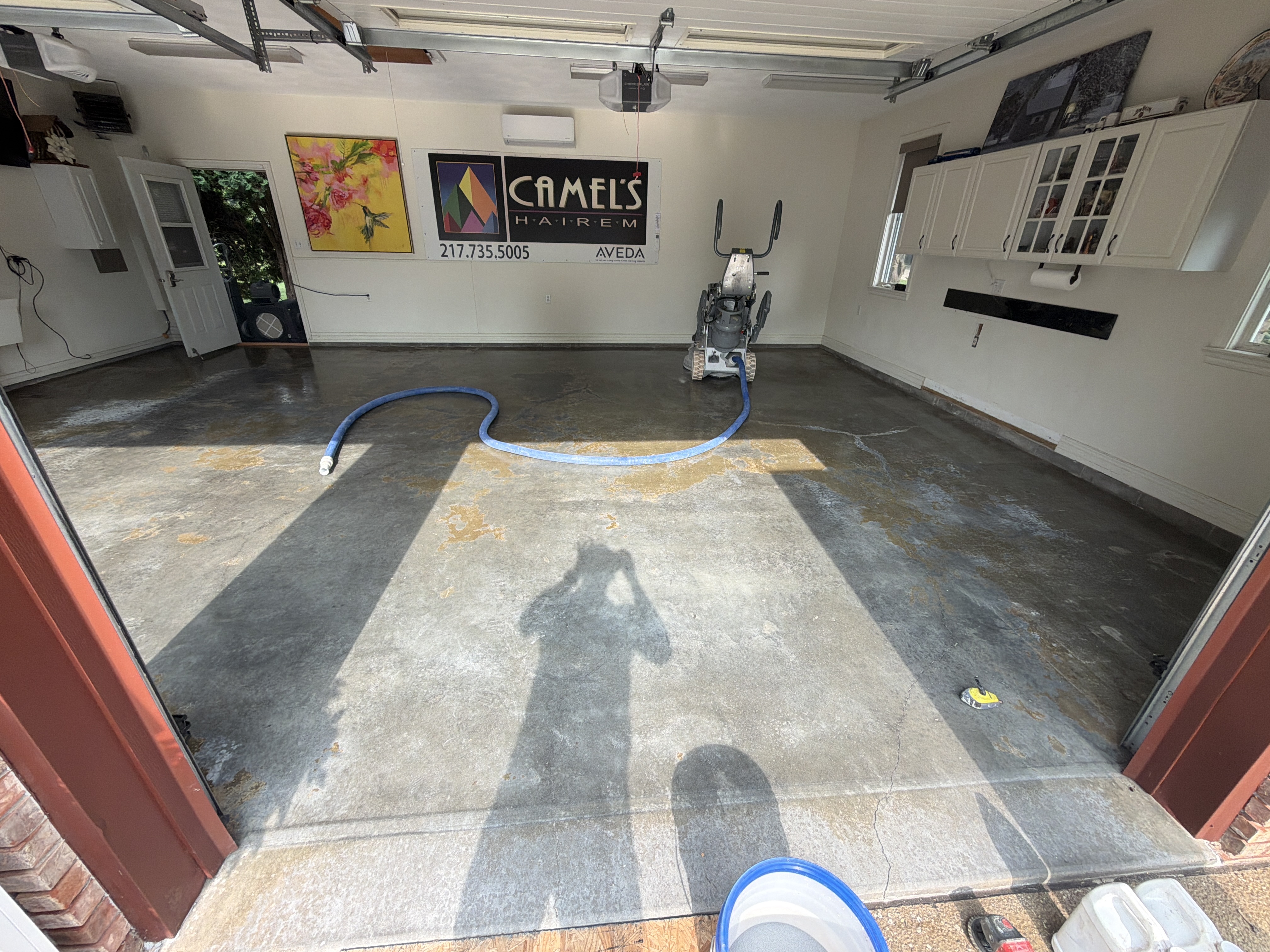 Original concrete floor showing stains and wear in John's Lincoln garage