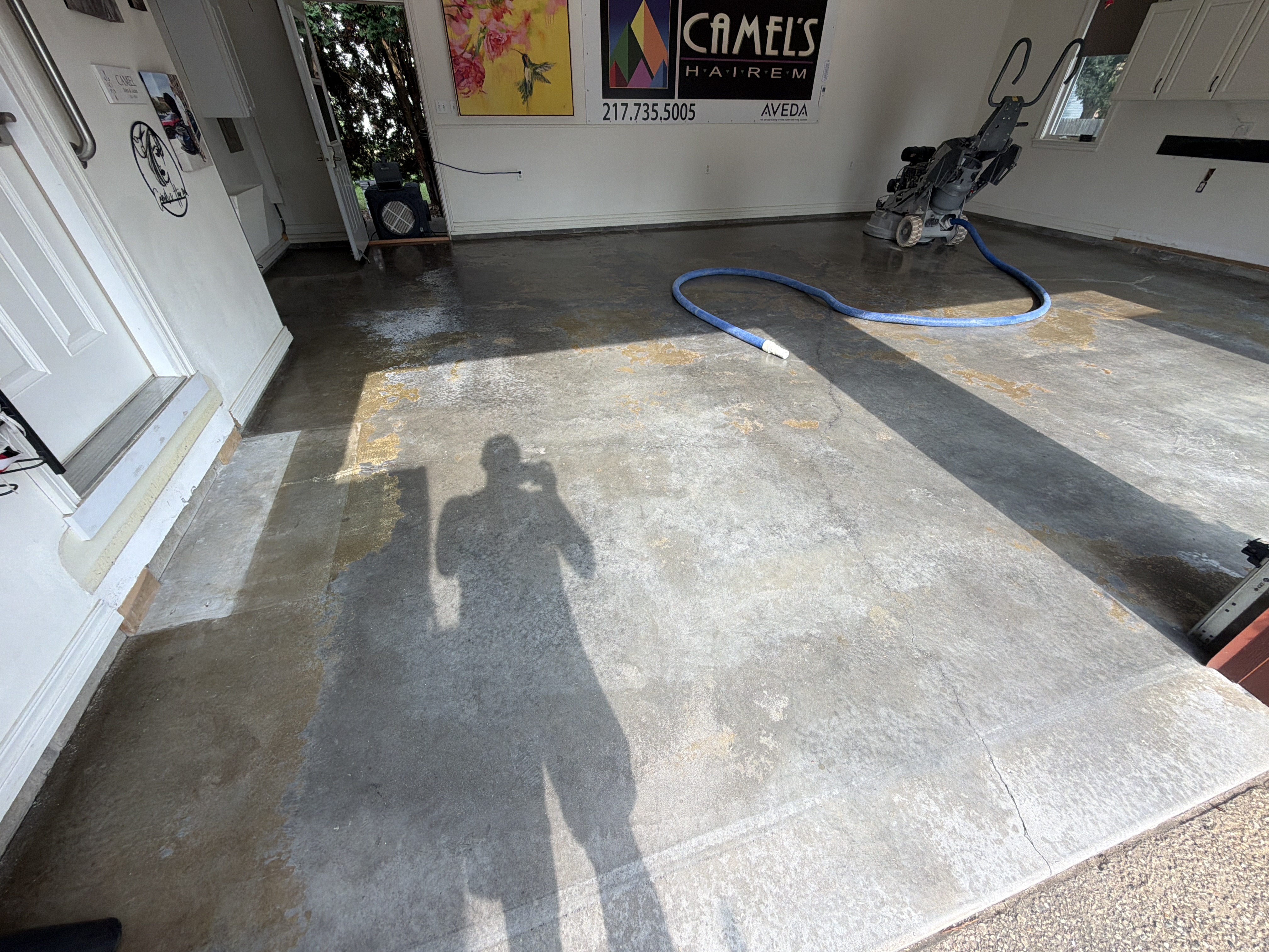 Close-up of existing damage and discoloration on John's garage floor